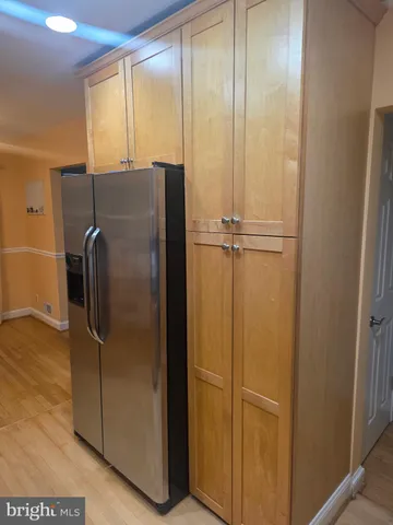 a view of a refrigerator in kitchen and a glass window