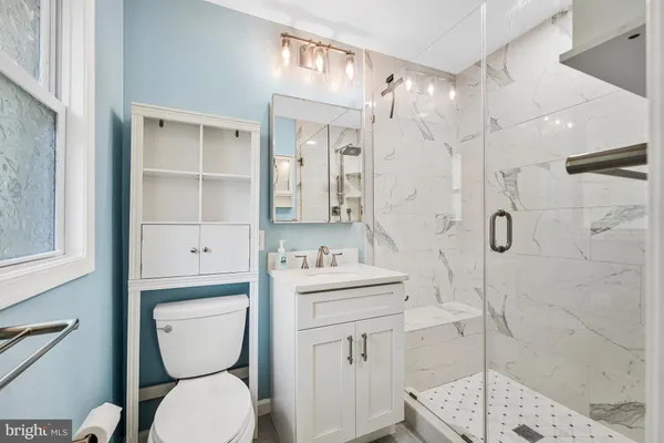 a bathroom with a double vanity sink a mirror and shower