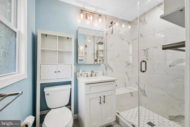 a bathroom with a double vanity sink a mirror and shower
