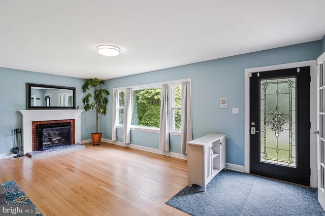 a view of an empty room with window and fire place