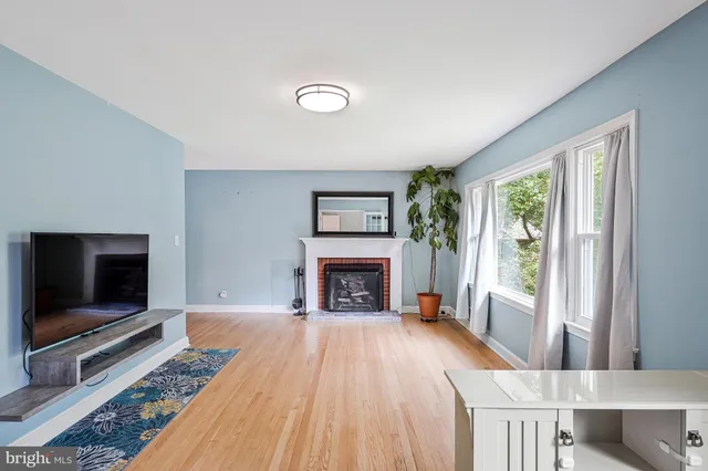 a living room with furniture fireplace and flat screen tv
