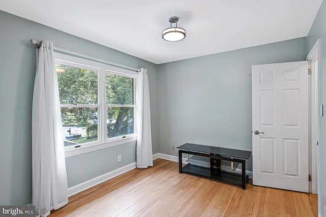 a view of room with window and wooden floor
