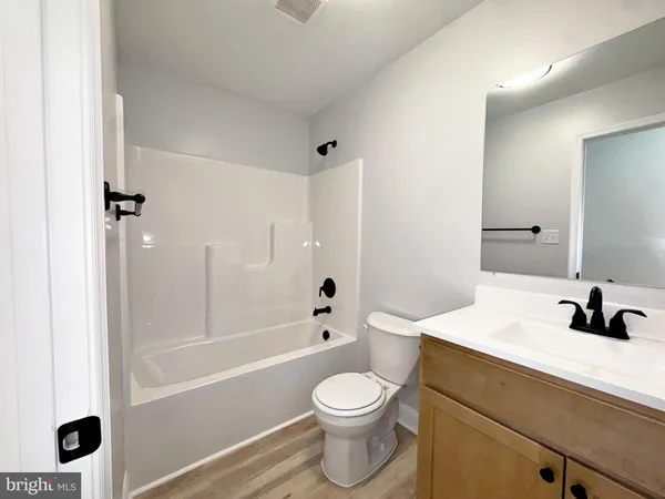a bathroom with a sink a toilet and a bathtub