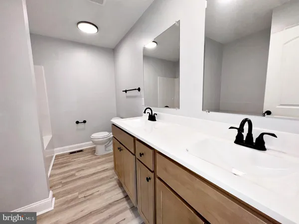 a bathroom with a double vanity sink and mirror