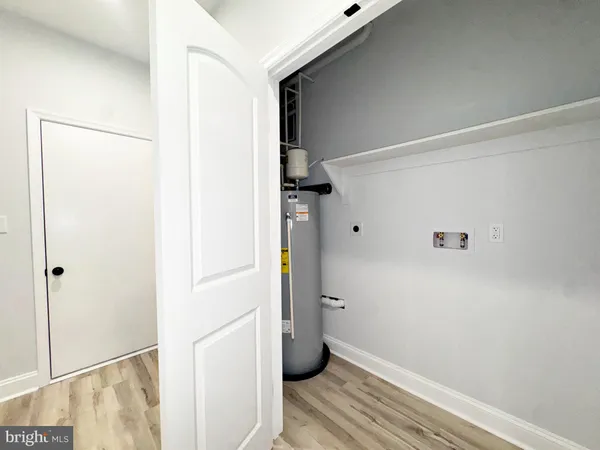 a view of storage and utility room with closet