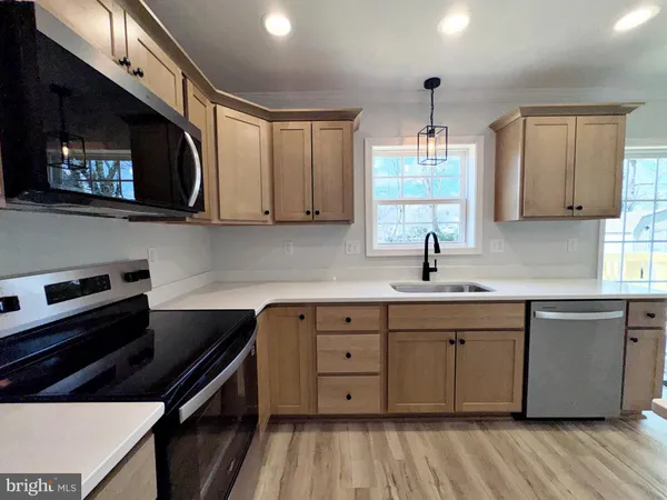 a kitchen with a sink stove and cabinets