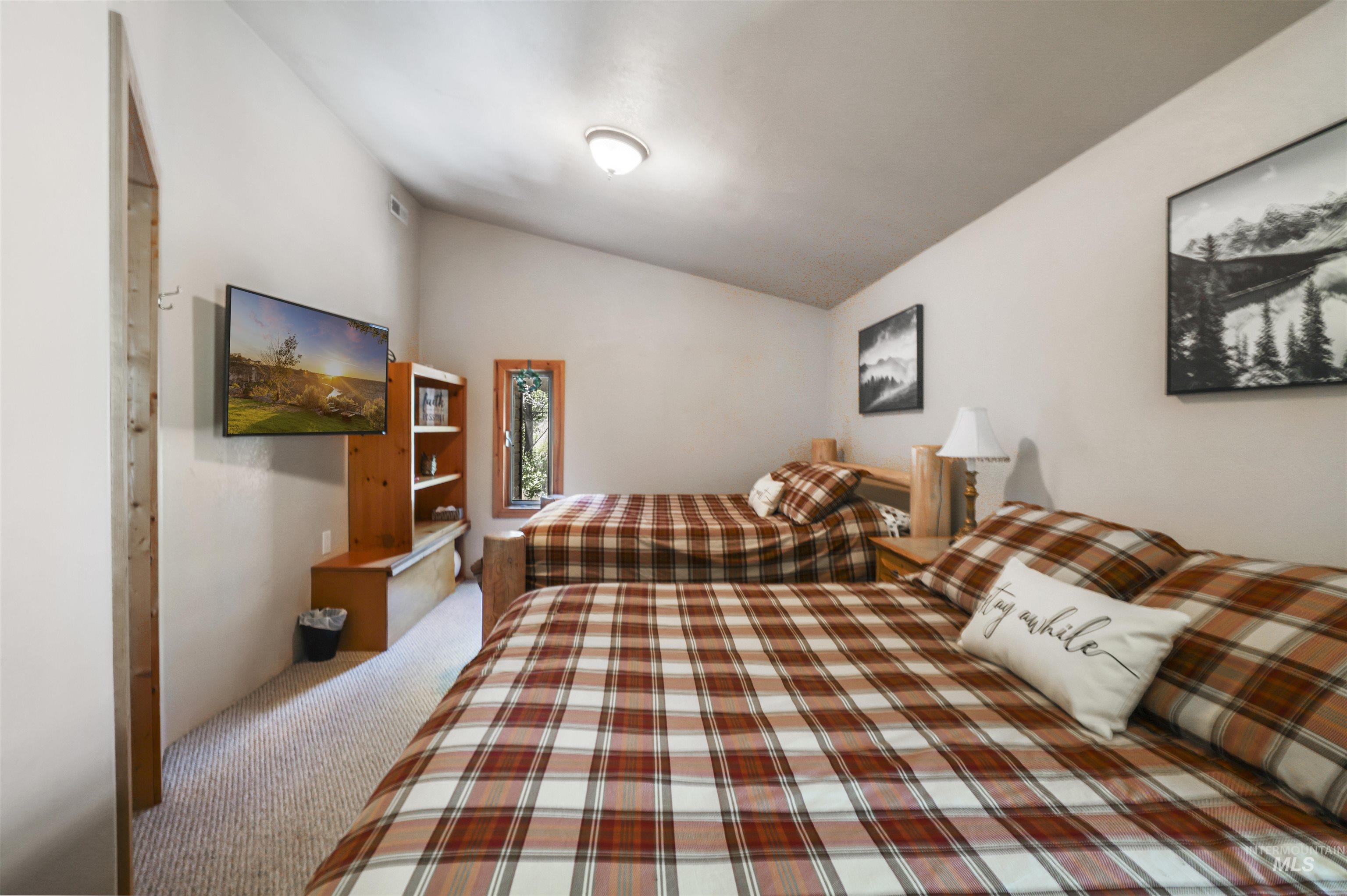 224 Dakota Road Mountain Home, ID 83647 - Photo 24 of 50 Carpeted room with a vaulted ceiling and a wall-mounted television