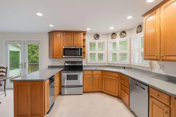 a kitchen with stainless steel appliances granite countertop a stove and a sink
