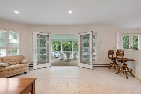 a living room with furniture and large windows
