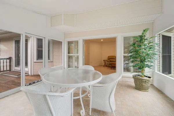 a dining room with furniture and potted plants