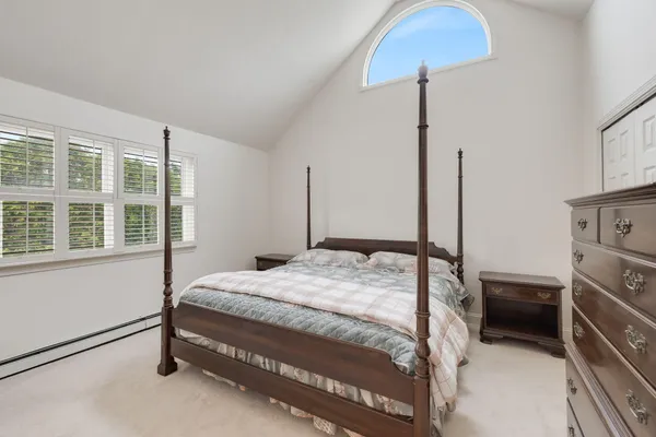a bed sitting in a bedroom next to a window