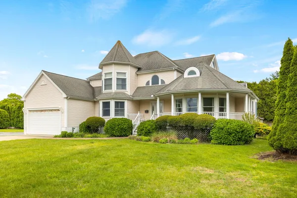 a front view of a house with a garden