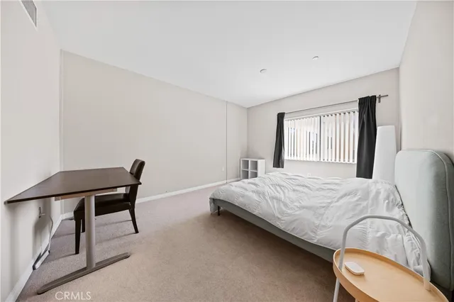 a bed room with a bed and a chair