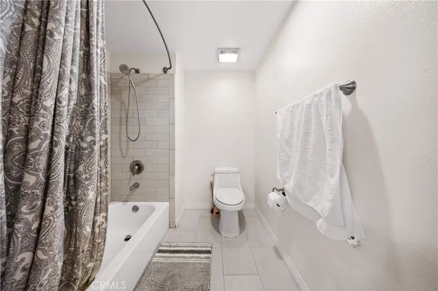 a bathroom with a toilet and a tub