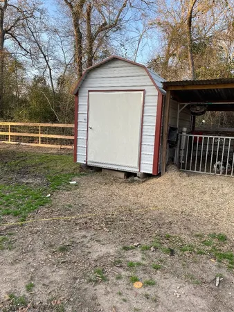 a view of a small house with a yard