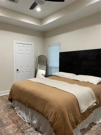 a bedroom with a bed and a painting on the wall
