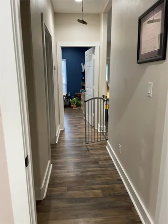 a view of a hallway with wooden floor