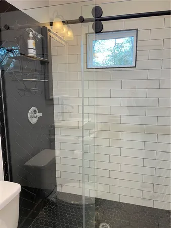 a bathroom with a shower and a toilet