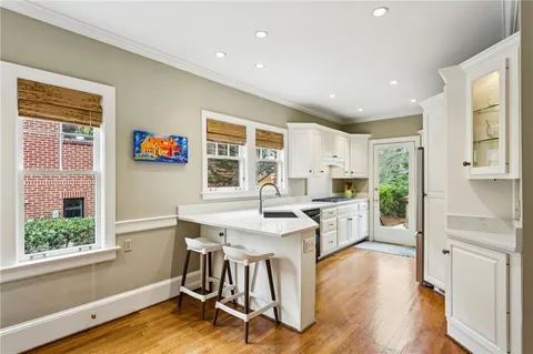a kitchen with white cabinets and appliances
