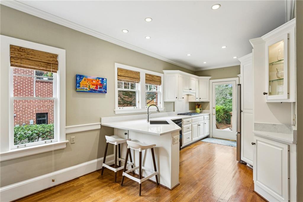 1686 Johnson Road Northeast Atlanta, GA 30306 - Photo 18 of 57 a kitchen with a table chairs refrigerator and cabinets