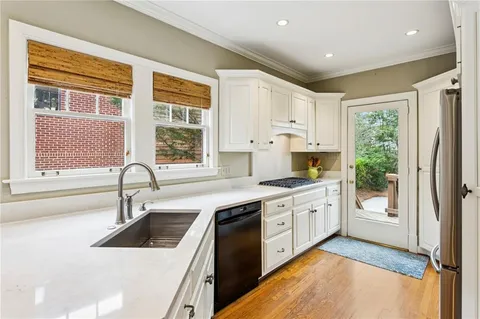 a kitchen with stainless steel appliances granite countertop a stove and a sink