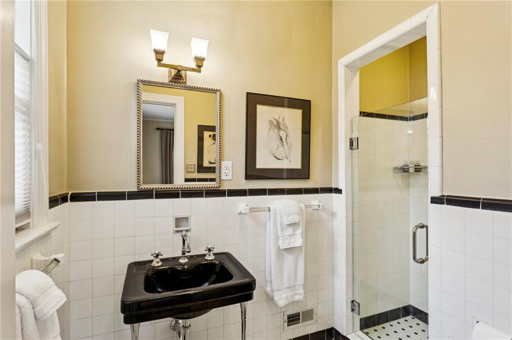 1686 Johnson Road Northeast Atlanta, GA 30306 - Photo 29 of 57 a bathroom with a sink a mirror and a shower