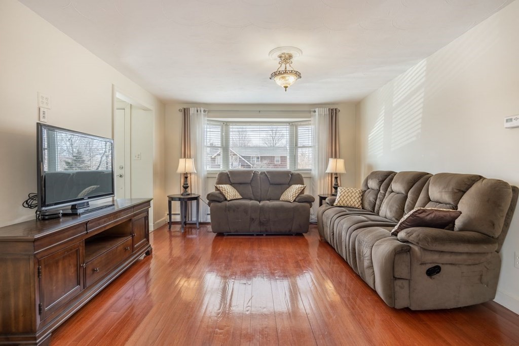 114 Lexington Road Billerica, MA 01821 - Photo 5 of 36 a living room with furniture and a flat screen tv