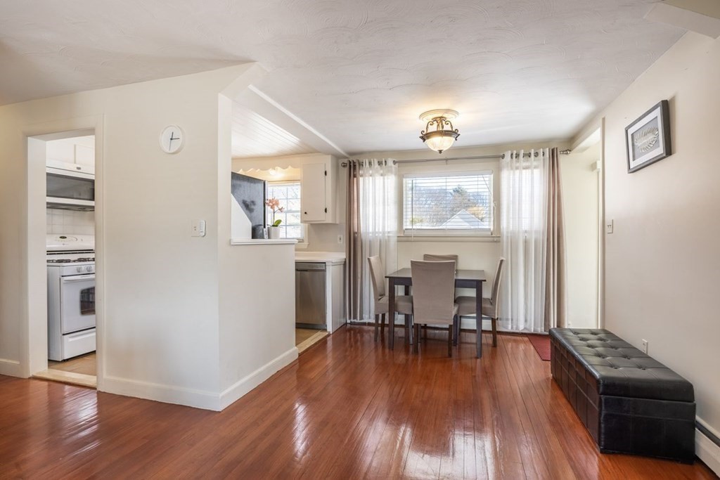 114 Lexington Road Billerica, MA 01821 - Photo 7 of 36 a view of a dining room with furniture window and wooden floor