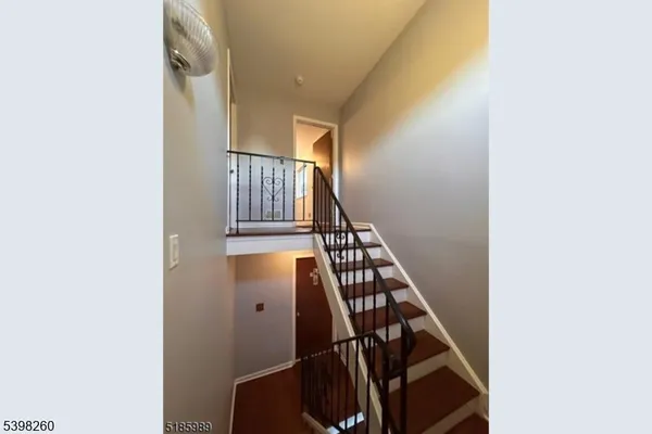 a view of staircase with wooden floor