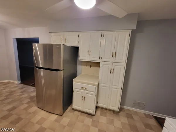 a kitchen with a refrigerator sink and cabinets