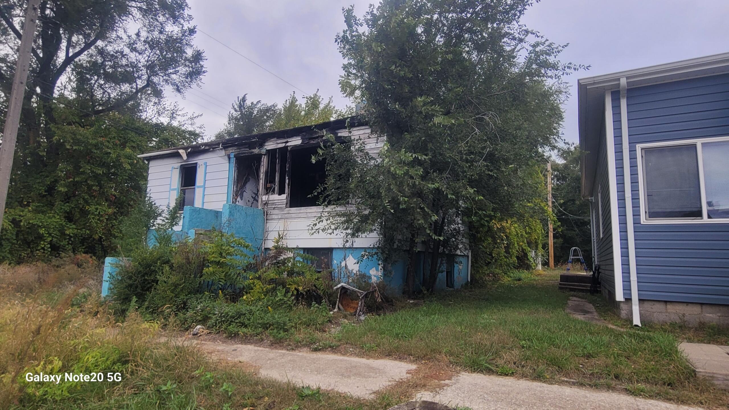 824 East 15th Avenue Gary, IN 46407 - Photo 3 of 10 a view of a house with a yard and tree s