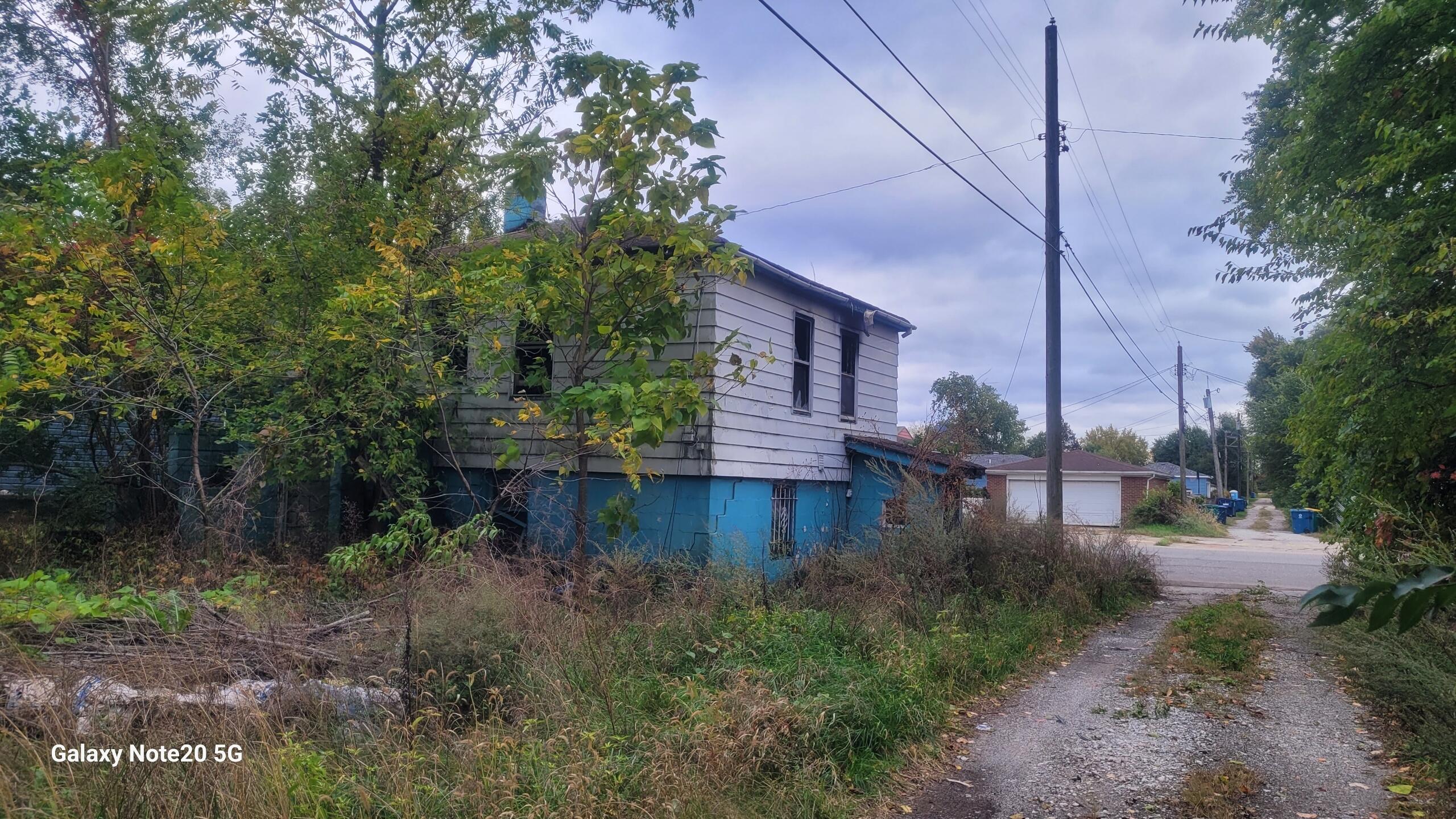 824 East 15th Avenue Gary, IN 46407 - Photo 8 of 10 a view of a house with a yard and tree s