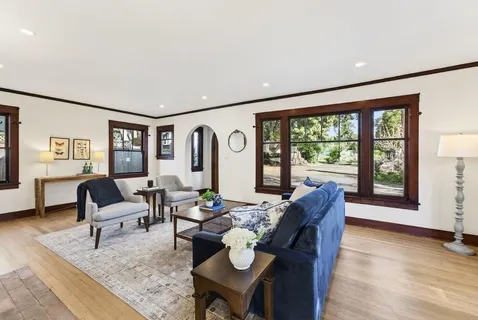 a living room with furniture and floor to ceiling windows