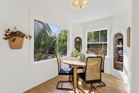 a view of a dining room with furniture window and outside view