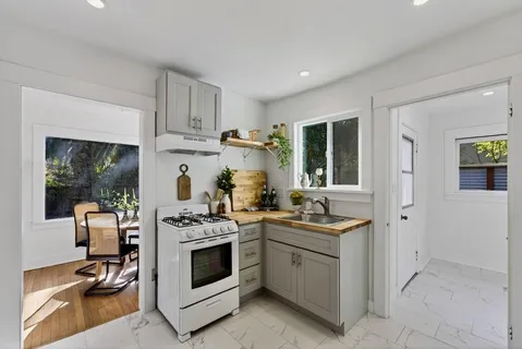 a kitchen with stainless steel appliances granite countertop a stove and a cabinets