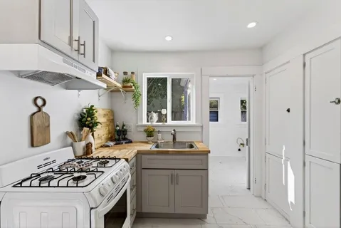a kitchen with a sink stove and refrigerator