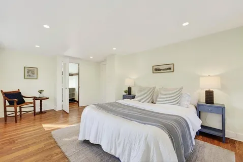a spacious bedroom with a bed and a table