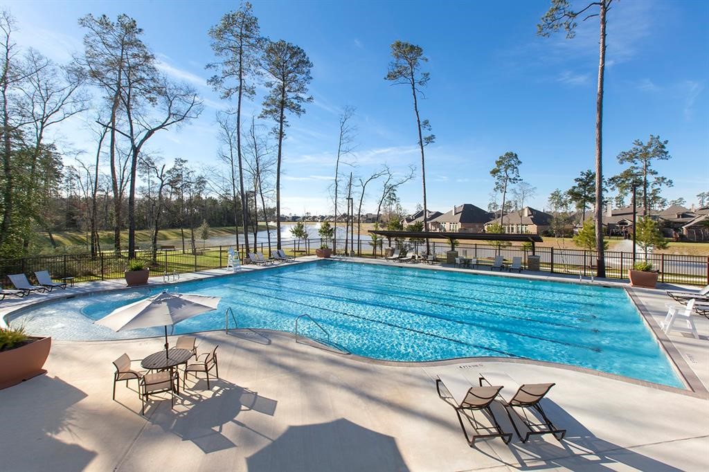 32110 Pond Pine Spring, TX 77386 - Photo 9 of 14 a view of a swimming pool with a sitting area