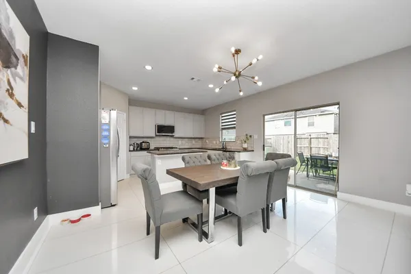 a dining room with furniture and window