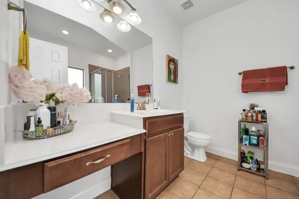 a bathroom with a toilet a sink and mirror