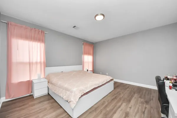 a bedroom with a bed and window