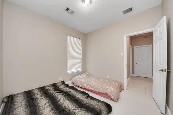 a bedroom with a bed and a window