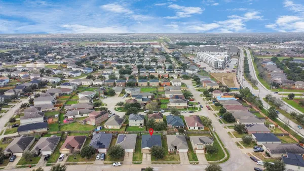 an aerial view of residential houses with city view