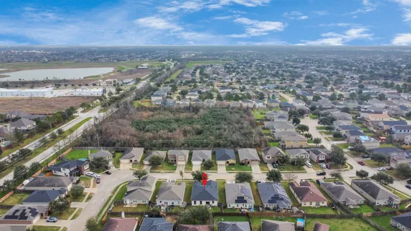 an aerial view of residential houses with outdoor space and street view