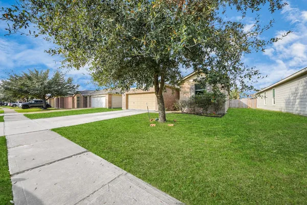 a view of backyard of house with green space