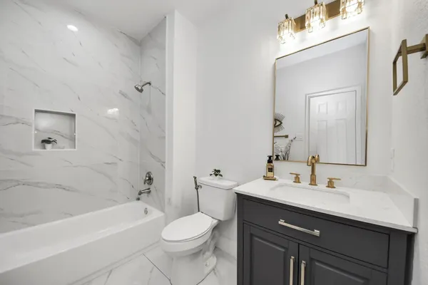 a bathroom with a sink a toilet and bathtub