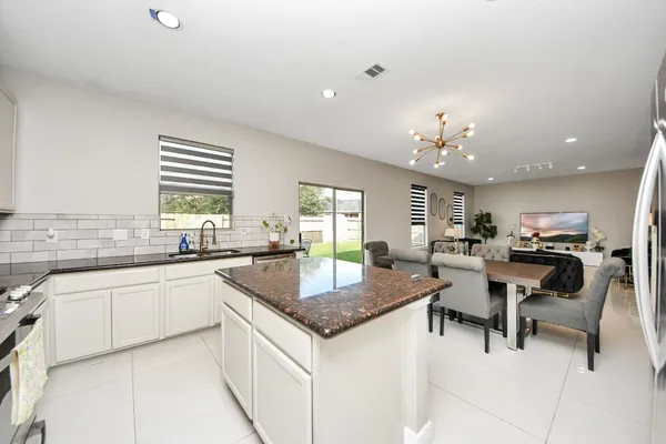 a kitchen with center island table and chairs