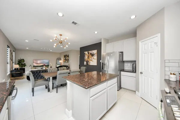 a kitchen with stainless steel appliances granite countertop a refrigerator and microwave