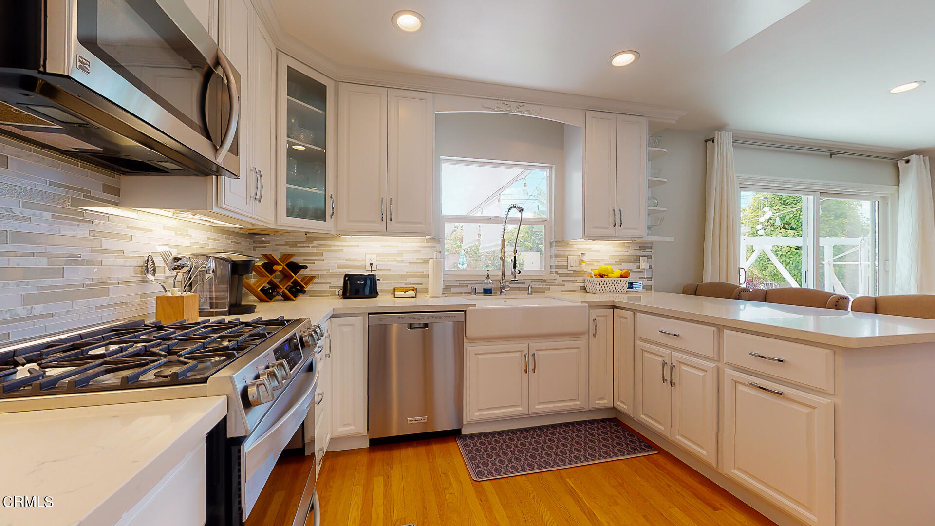 11052 Corley Drive Whittier, CA 90604 - Photo 11 of 39 a kitchen with stainless steel appliances a sink dishwasher stove and white cabinets
