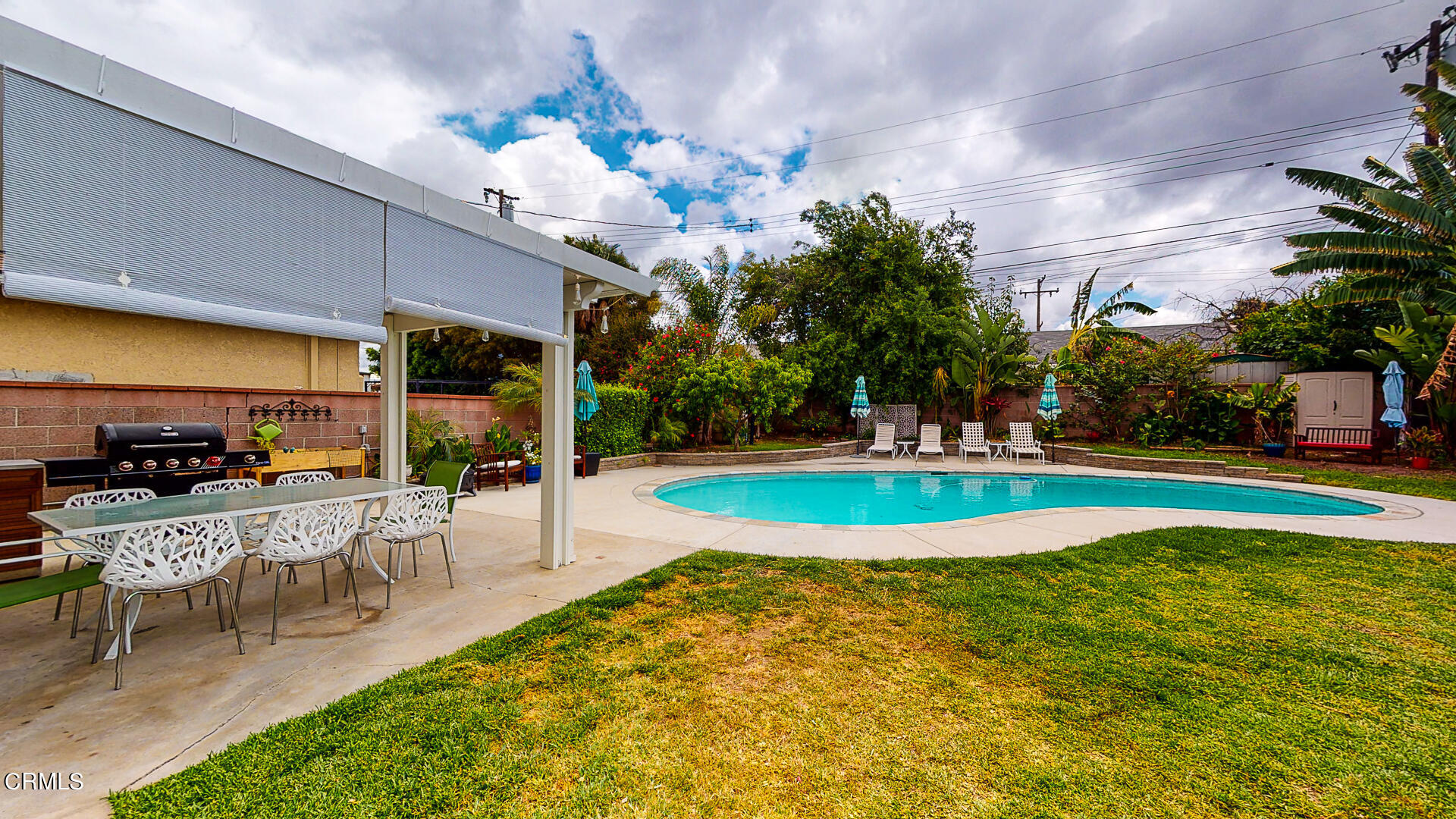 11052 Corley Drive Whittier, CA 90604 - Photo 32 of 39 a view of a swimming pool with table and chairs potted plants and large tree